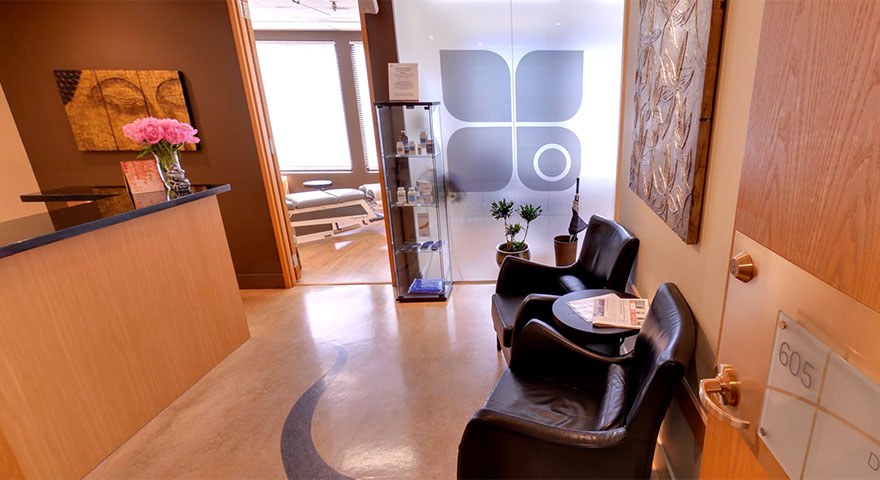 The Downtown Wellness Centre reception at Suite 605, with the clinic's logo on the glass